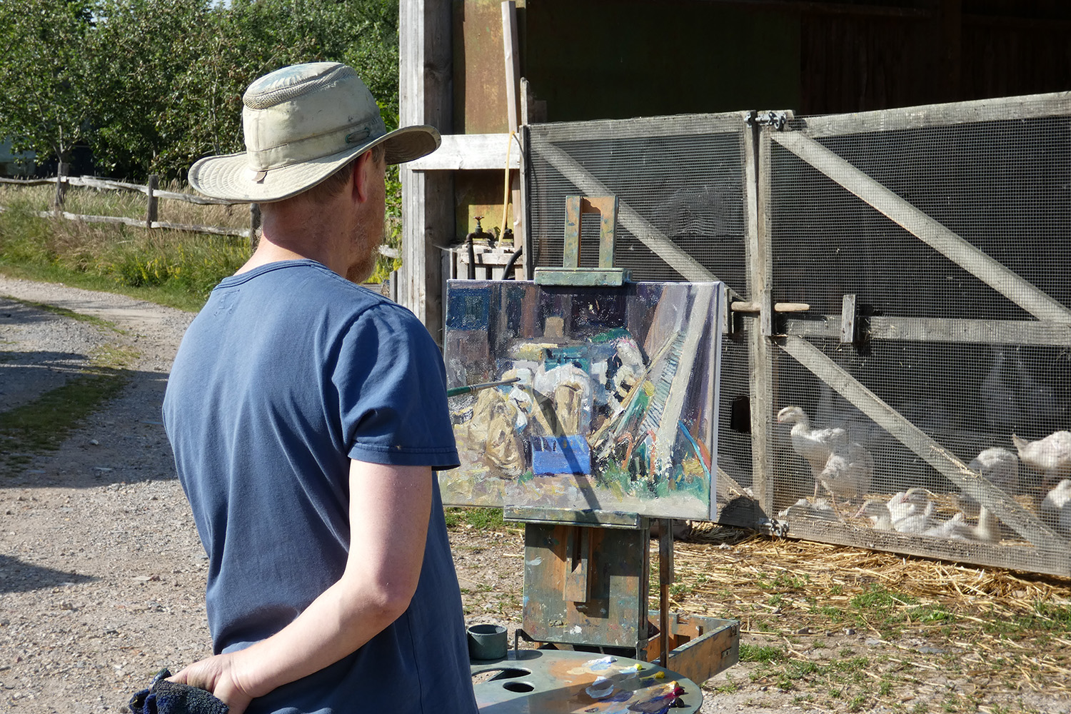 Tom painting in yard